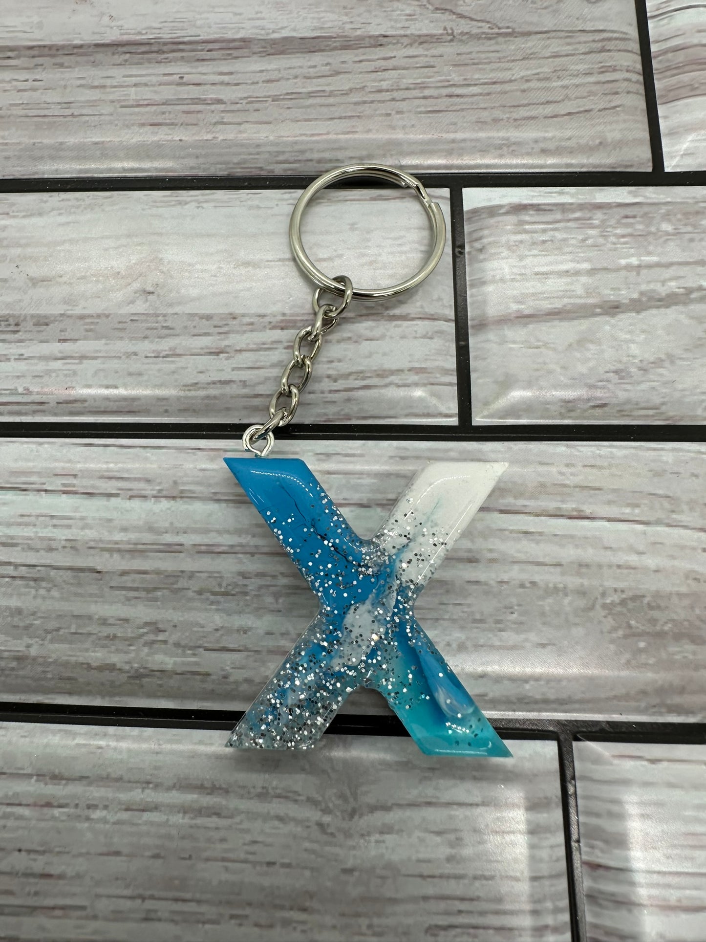 Shimmering Blue and White Resin Letter X Keychain