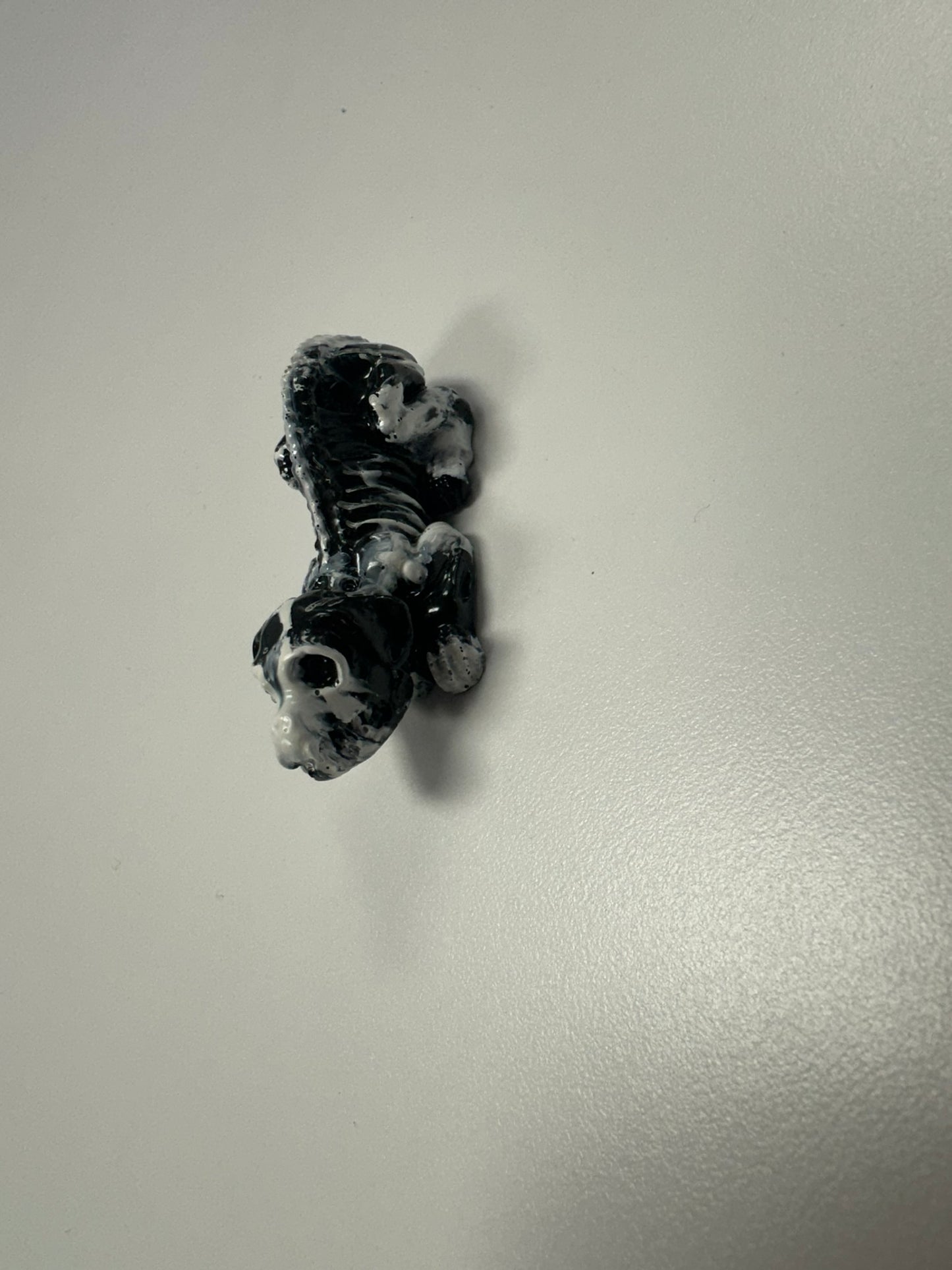 Marbled Madness: Black and White Skull Dog Figurine