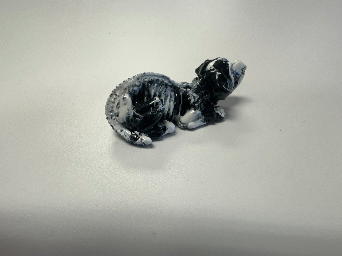 Marbled Madness: Black and White Skull Dog Figurine